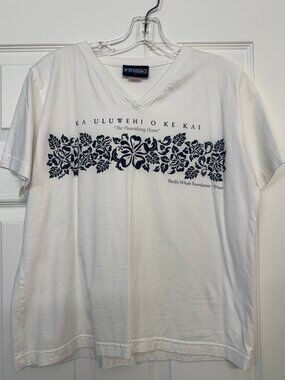 White cotton v-neck t-shirt with Hawaiian flowers and "bountiful seas" imprint